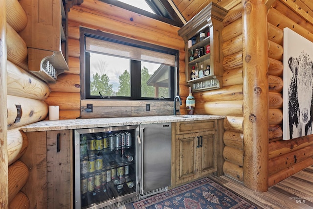 14051 Deerfield Rd, Mccall, ID 83638 - indoor wet bar featuring wood finished floors, wine cooler, log walls, and vaulted ceiling