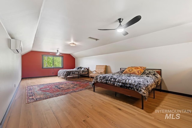 14051 Deerfield Rd, Mccall, ID 83638 - bedroom with a wall mounted air conditioner, vaulted ceiling, wood finished floors, and a ceiling fan