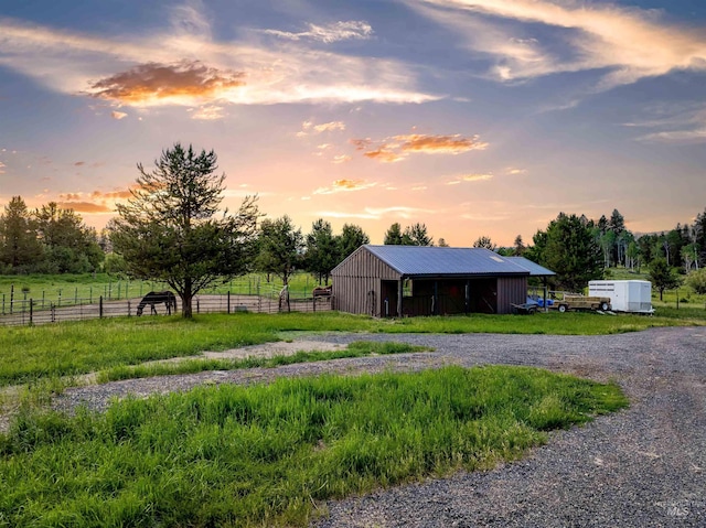 14051 Deerfield Rd, Mccall, ID 83638 - yard at dusk featuring an outdoor structure, a pole building, and a view of countryside