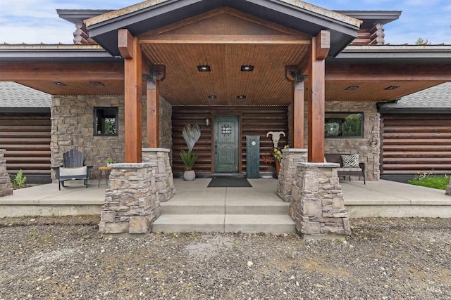 14051 Deerfield Rd, Mccall, ID 83638 - entrance to property featuring a porch, log exterior, and roof with shingles