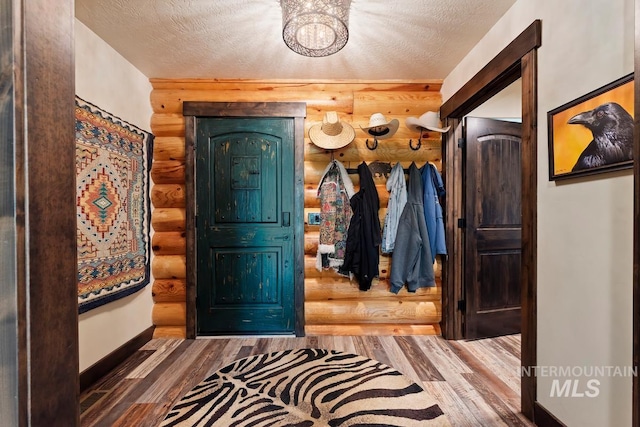 14051 Deerfield Rd, Mccall, ID 83638 - foyer entrance with rustic walls, wood finished floors, and a textured ceiling