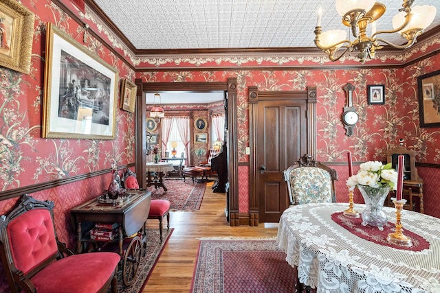 interior space featuring ornamental molding, hardwood / wood-style floors, and a chandelier