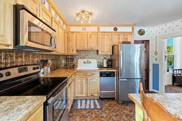 kitchen with light brown cabinetry, light stone counters, appliances with stainless steel finishes, and tasteful backsplash