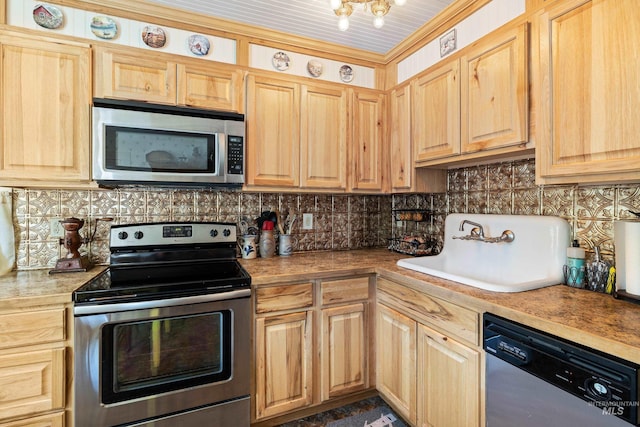 kitchen featuring ornamental molding, appliances with stainless steel finishes, tasteful backsplash, and sink