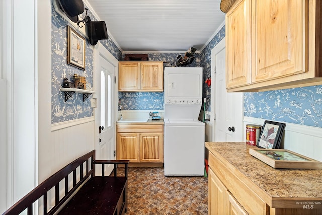 kitchen with light brown cabinets and stacked washing maching and dryer