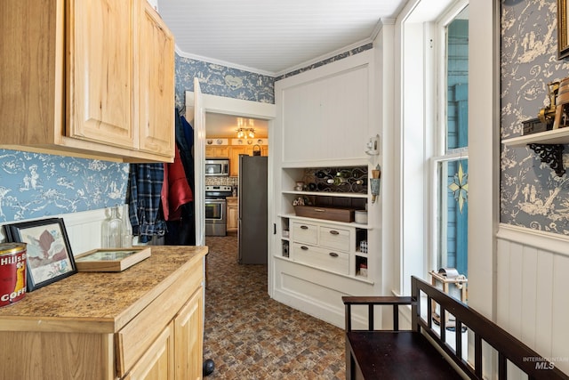 kitchen featuring light brown cabinetry and stainless steel appliances