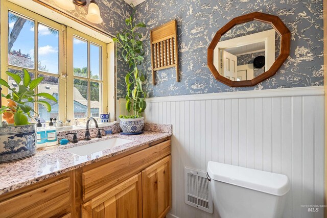 bathroom with vanity, toilet, and a water view