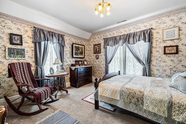 carpeted bedroom with an inviting chandelier