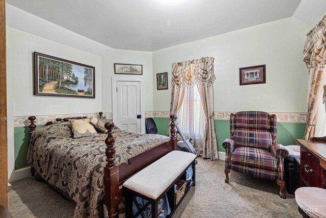 bedroom with light colored carpet and vaulted ceiling