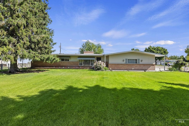 93 S Lancaster Dr, Nampa, ID 83651 - back of property featuring brick siding, a chimney, and a lawn
