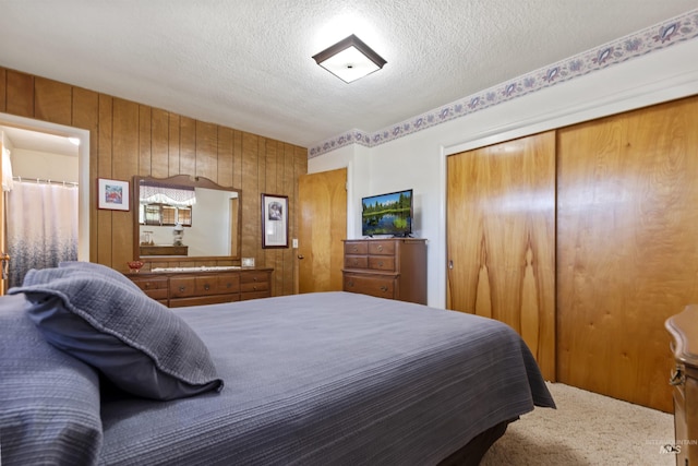 93 S Lancaster Dr, Nampa, ID 83651 - bedroom featuring a textured ceiling, a closet, carpet floors, and wooden walls