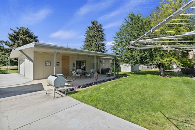 93 S Lancaster Dr, Nampa, ID 83651 - back of house featuring a yard, a patio, and driveway