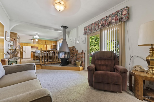 93 S Lancaster Dr, Nampa, ID 83651 - living area featuring a wood stove, ornamental molding, light carpet, and arched walkways
