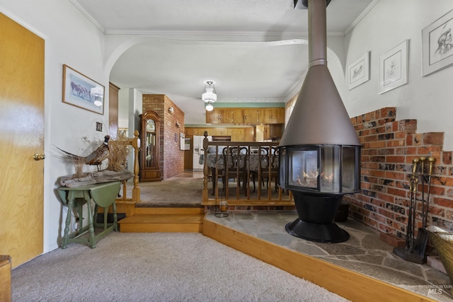 93 S Lancaster Dr, Nampa, ID 83651 - living room featuring a wood stove, carpet flooring, ornamental molding, and arched walkways