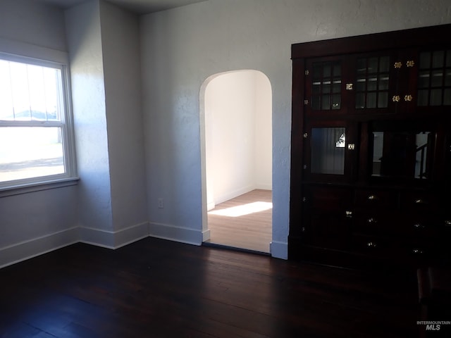 spare room featuring dark wood-type flooring