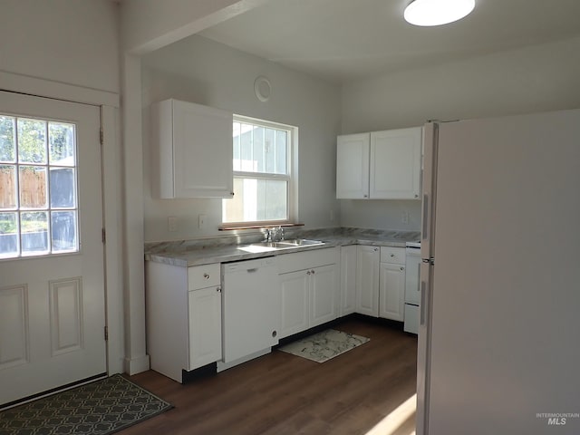 kitchen featuring dark wood-type flooring, sink, white appliances, and white cabinetry