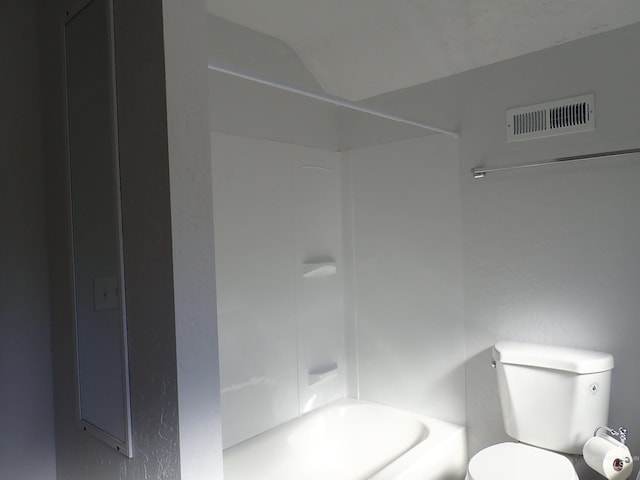 bathroom with bathing tub / shower combination and toilet