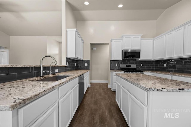 4991 N Sun Shimmer Ave, Meridian, ID 83646 - kitchen featuring appliances with stainless steel finishes, a sink, backsplash, white cabinets, and recessed lighting