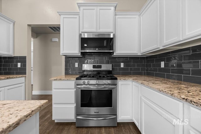 4991 N Sun Shimmer Ave, Meridian, ID 83646 - kitchen featuring stainless steel appliances, dark wood finished floors, white cabinets, and backsplash