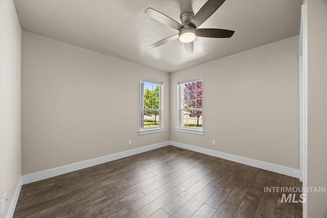 4991 N Sun Shimmer Ave, Meridian, ID 83646 - spare room with dark wood-type flooring, a ceiling fan, baseboards, and a textured ceiling