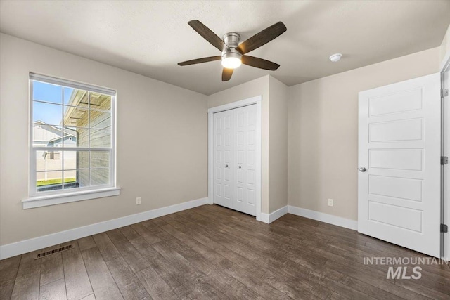 4991 N Sun Shimmer Ave, Meridian, ID 83646 - unfurnished bedroom featuring dark wood-type flooring, baseboards, and a closet