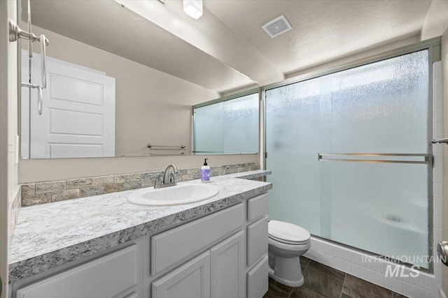 4991 N Sun Shimmer Ave, Meridian, ID 83646 - bathroom featuring toilet, vanity, and a stall shower