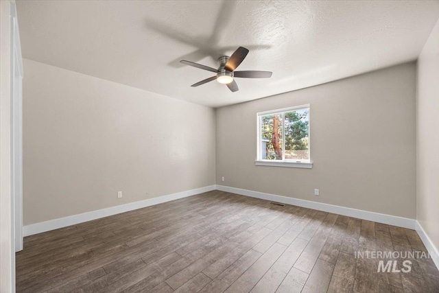 4991 N Sun Shimmer Ave, Meridian, ID 83646 - spare room featuring a ceiling fan, wood finished floors, baseboards, and a textured ceiling