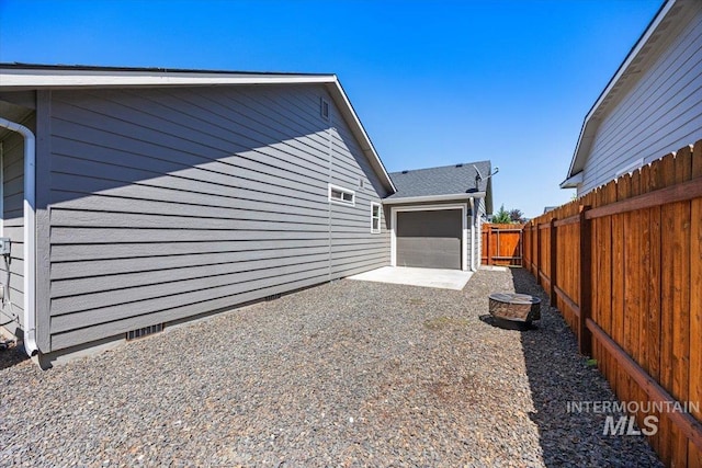 4991 N Sun Shimmer Ave, Meridian, ID 83646 - view of property exterior featuring a fenced backyard, a patio area, and driveway