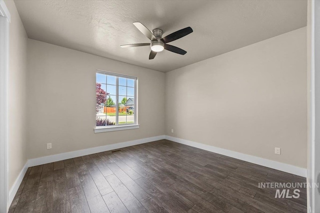 4991 N Sun Shimmer Ave, Meridian, ID 83646 - unfurnished room with dark wood-style flooring, ceiling fan, and baseboards