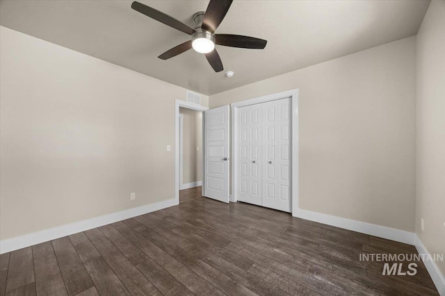 4991 N Sun Shimmer Ave, Meridian, ID 83646 - unfurnished bedroom featuring dark wood-style floors, baseboards, a closet, and a ceiling fan