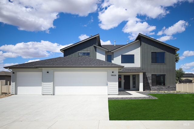 view of front of home with a garage and a front lawn