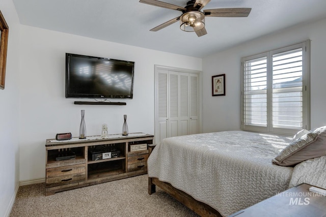 bedroom featuring ceiling fan, light colored carpet, and a closet