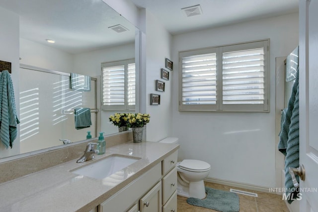 bathroom with walk in shower, tile patterned floors, toilet, and vanity