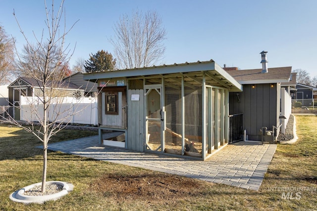 view of outbuilding with a yard