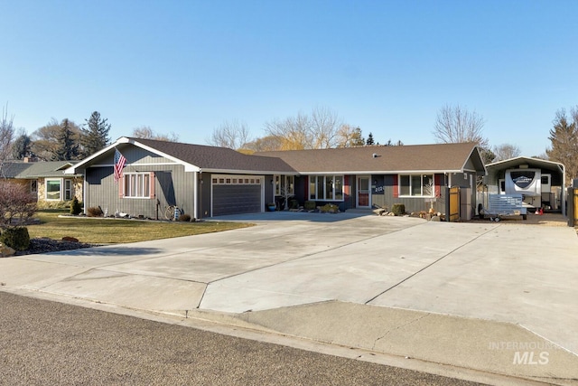 ranch-style home featuring a garage, a carport, and a front lawn