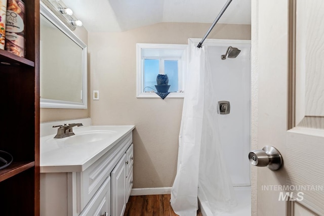 bathroom with hardwood / wood-style flooring, vanity, lofted ceiling, and a shower with shower curtain