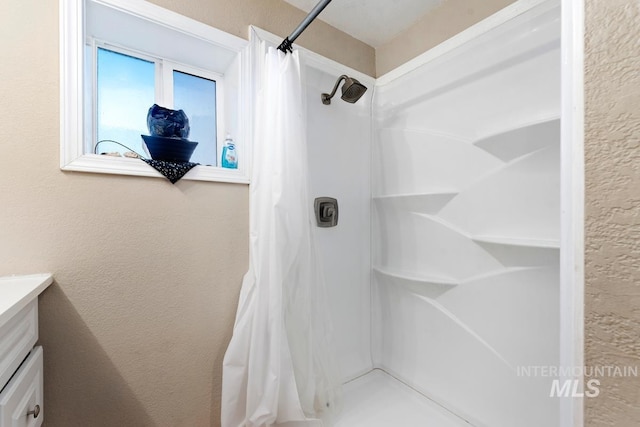 bathroom featuring vanity and a shower with shower curtain