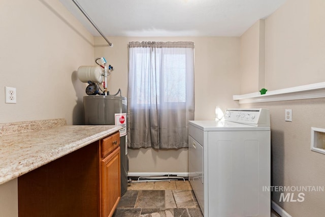 clothes washing area with washer / clothes dryer, cabinets, and electric water heater