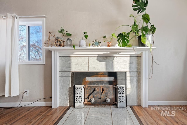 interior details featuring hardwood / wood-style flooring and a fireplace