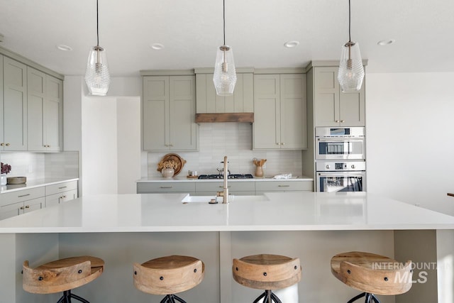 kitchen featuring light countertops and a kitchen breakfast bar