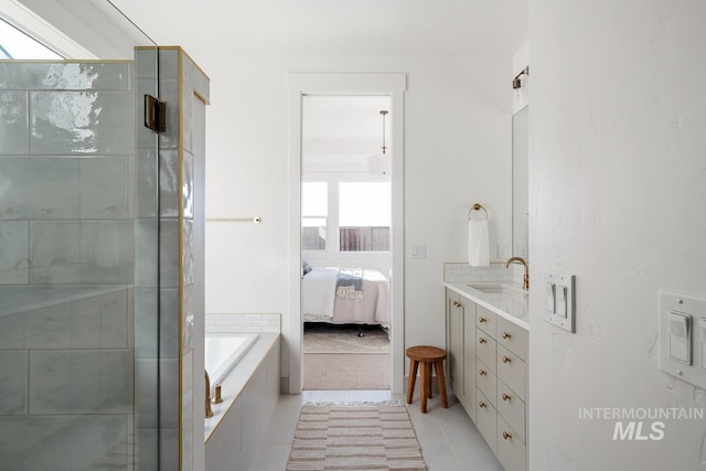 ensuite bathroom featuring a tub to relax in, tile patterned flooring, connected bathroom, vanity, and a shower with door