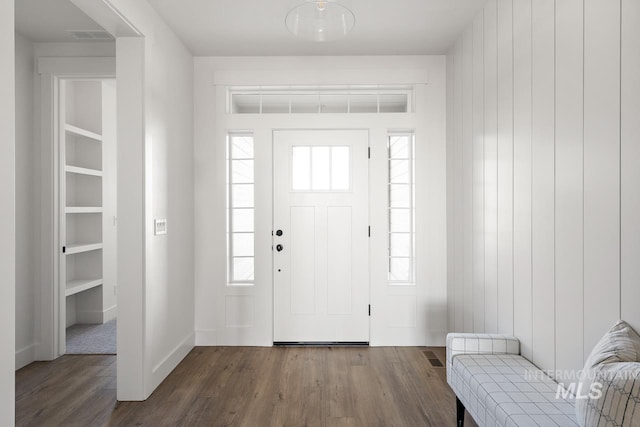 entryway with visible vents, baseboards, and wood finished floors