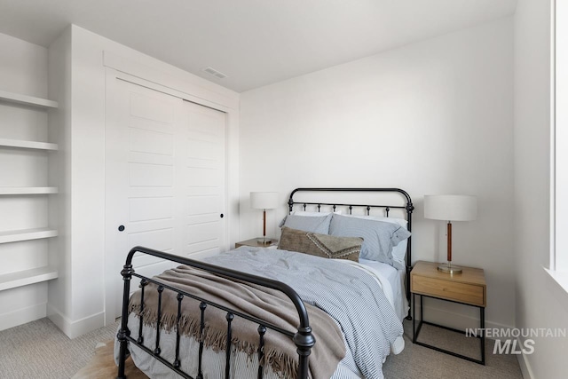 carpeted bedroom featuring a closet