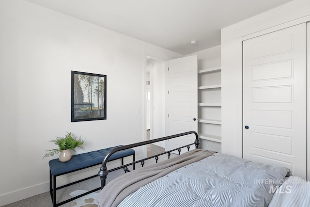 bedroom featuring carpet and baseboards