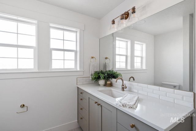 bathroom featuring toilet and vanity