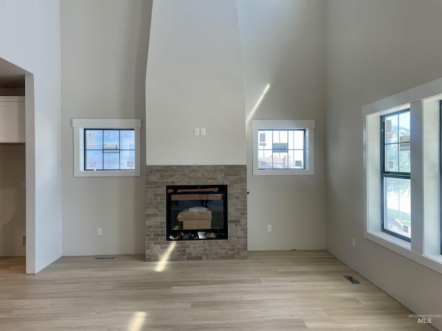 1640 E Cutgrass Ln, Eagle, ID 83616 - unfurnished living room with a high ceiling, wood finished floors, and healthy amount of natural light