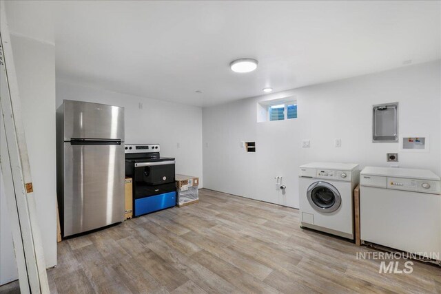 539 Rimview Dr, Twin Falls, ID 83301 - laundry room with light wood-type flooring, independent washer and dryer, and electric panel