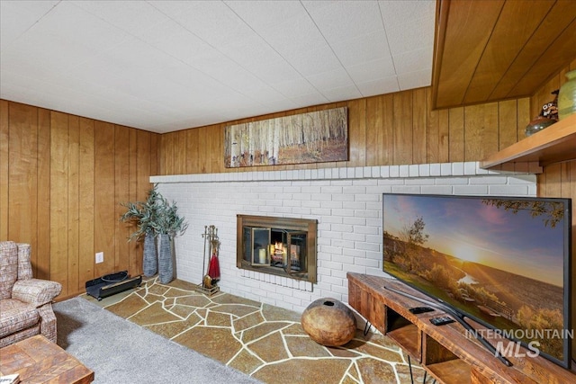 539 Rimview Dr, Twin Falls, ID 83301 - living area with wood walls, a fireplace, and carpet floors