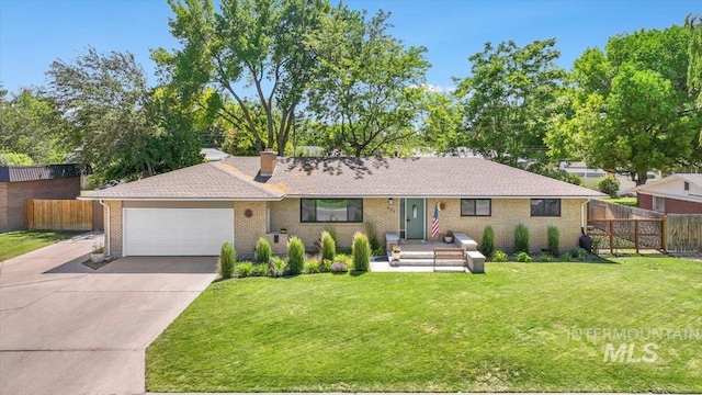 539 Rimview Dr, Twin Falls, ID 83301 - ranch-style house with driveway, an attached garage, a chimney, and brick siding