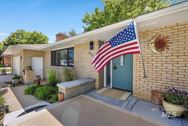 539 Rimview Dr, Twin Falls, ID 83301 - property entrance with a chimney and brick siding